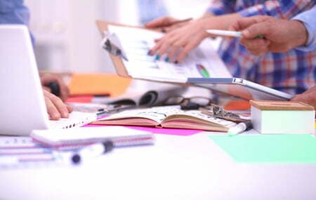 45468659 - close-up of three young creative designers working on project together. team work.